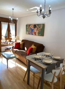 a living room with a table and a couch at Balcón del atardecer in Cangas de Onís