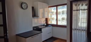 a kitchen with a clock on a white wall at Casa Vacanze Chiara in Francavilla al Mare
