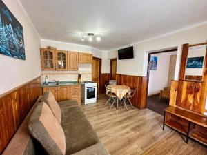 a living room with a couch and a table at Privat Horec in Malý Slavkov