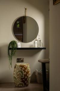 a bathroom with a sink and a mirror on a wall at Fairyhill in Reynoldston