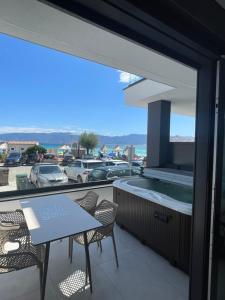 a balcony with a hot tub and a table and chairs at Villa San Sebastian-Baška in Baška