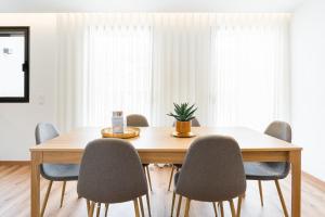 a dining room table with chairs and a plant on it at GuestReady – The Mythic Apartments in Porto