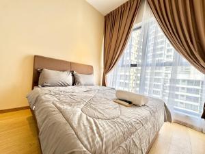 a bedroom with a bed with a laptop on it at Kingsbay Danga Bay Country Garden by Luxecocoo CK in Johor Bahru