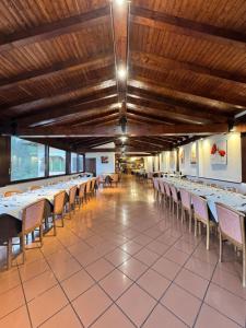 a dining hall with tables and chairs in a building at Antiche Terre Hotel & Relax in Pignone