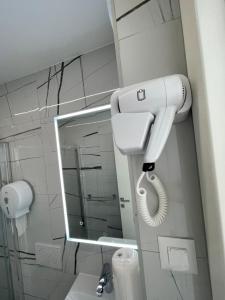 a bathroom with a blow dryer and a mirror at Villa San Sebastian-Baška in Baška +5 photos
