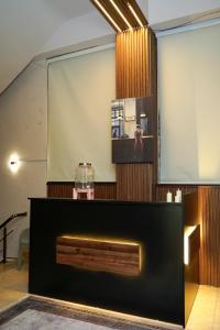 a large screen in a room with a fireplace at موتيل رامي سكاي Motel Rami Sky in Erbil