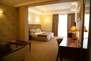 a hotel room with a bed and a couch at Capitol Hotel Stay in Baku