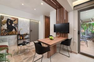 a living room with a dining room table and chairs at Masarou Suites in Afantou
