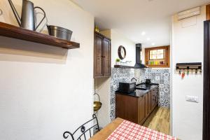 a kitchen with a table and a counter top at Vintage Suite in Cagliari +6 photos