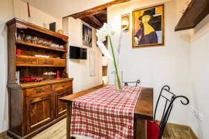 a kitchen with a table with a vase of flowers on it at Vintage Suite in Cagliari