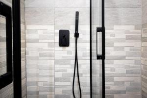 a shower in a bathroom with a glass door at Vintage Suite in Cagliari