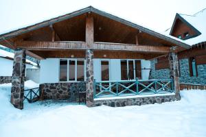 a house in the snow with snow covered at Kottage ji in Bakuriani