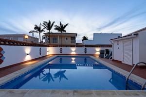 a swimming pool in the backyard of a house at night at Villa Leonie in Lagos +53 photos