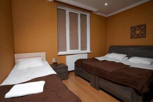 a bedroom with two beds and a window at Kottage ji in Bakuriani