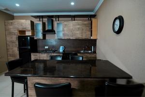 a kitchen with a table and a clock on the wall at Kottage ji in Bakuriani +3 photos