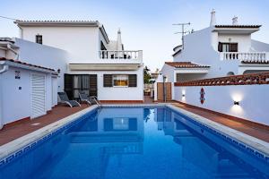 a swimming pool in front of a villa at Villa Leonie in Lagos