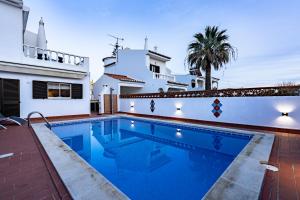 a swimming pool in front of a house at Villa Leonie in Lagos