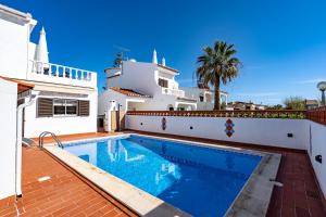 a villa with a swimming pool and a house at Villa Leonie in Lagos