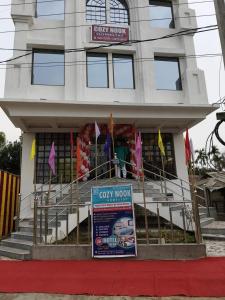 a building with a sign in front of it at Cozy Nook Home Stay in Dharmanagar