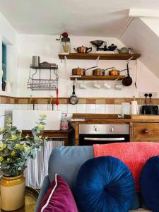 a living room with a couch and a kitchen at The Pepper Pot Sleeps 4 Sunlit Garden in Exmouth