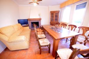 a living room with a couch and a table and chairs at Casas Rurales el Jardín in Jorquera