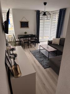 a living room with a couch and a table at Dreamhopp28 - Küche, bis zu 4 Personen in Magdeburg