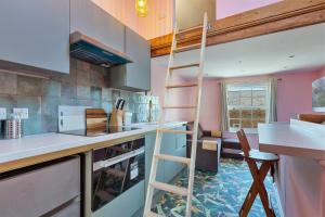 a kitchen with a ladder in the middle of a room at Finest Retreats - The Nest in London