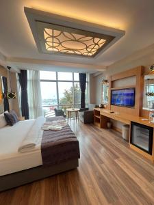 a bedroom with a large bed and a television at The Port Rooms in Sinop +127 photos