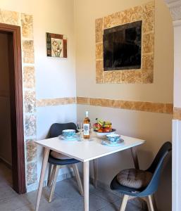 a white table and chairs with food on it at TheOldHouse Seaview in Corfu