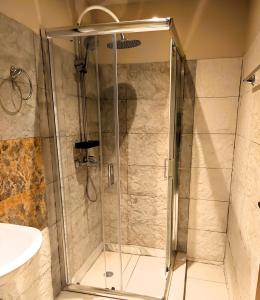 a shower with a glass door in a bathroom at TheOldHouse Seaview in Corfu +15 photos