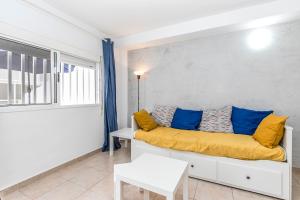 a living room with a couch and a window at Relax by the Sea at Medano Retreat Terrace Pool in El Médano +34 photos