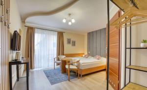 a hotel room with a bed and a table at Pensjonat PANORAMA in Karpacz +32 photos