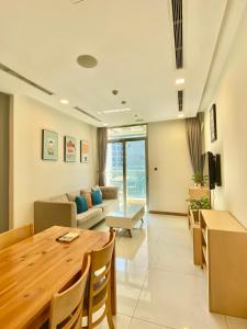 a living room with a table and a couch at Central Apartments - Vinhomes Central Park, Landmark 81 Area & Ice Skating Rink in Ho Chi Minh City