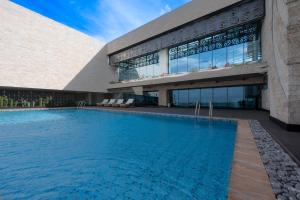 a swimming pool in front of a building at Hyatt House Nairobi Westlands in Nairobi