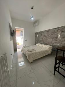 a bedroom with a bed and a brick wall at Vitiello Maria's home in Pompei