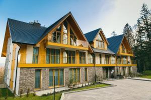 a large house with a metal roof at Apartament Ulubiony Mariental Residence in Szklarska Poręba