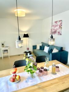 a table with fruits and glasses on top of it at Claudia's Seeherz in Wasserburg am Bodensee