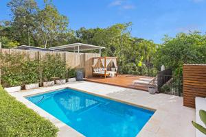 a swimming pool in the backyard of a house at Large Family Home with Pool & Spa in Brisbane +21 photos