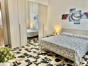 a bedroom with two beds and a mirror at Casa Giulia in Cardedu