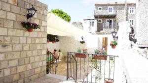 a building with a balcony with plants and flowers at Guest House Bonaca in Ulcinj