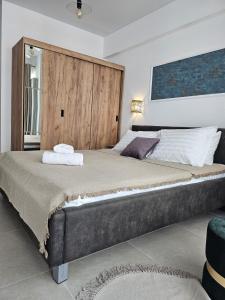 a bedroom with a large bed with a wooden headboard at Apartament mamaia nord - Alezzi odyssey in Mamaia Nord