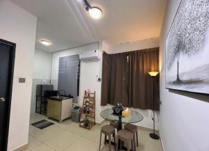 a room with a table and chairs and a window at Pep Homestay in Donggongon