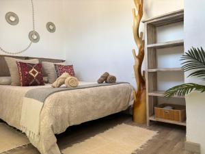 a bedroom with a bed and a book shelf at Little Paradise in El Médano in Granadilla de Abona +20 photos