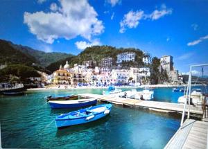 two boats are docked at a dock in a harbor at Cantone Studio On The Beach in Cetara