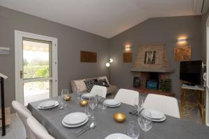 a dining room with a table with white chairs and a tableablish at President Villa Tuerredda in Chia
