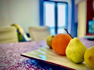 a pile of fruit on a plate on a table at Balcon del Mar in Dramalj