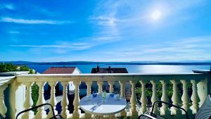 a white balcony with a table and chairs on it at Balcon del Mar in Dramalj +28 photos
