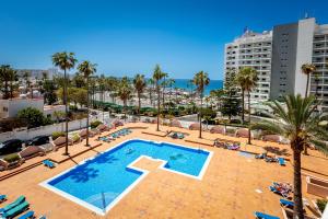 an overhead view of a swimming pool with palm trees and buildings at Lovely Acapulco Playa de Las Americas in Playa de las Americas