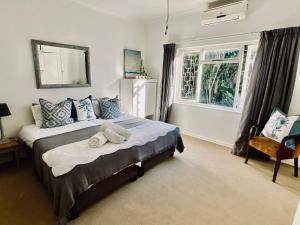 a bedroom with a bed with a towel on it at Sagelands for business travel & family getaways in Durban
