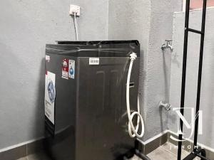 a water tank in a bathroom with a hose at Majestic Maxim UCSI 2R near MRT #22 in Kuala Lumpur +22 photos